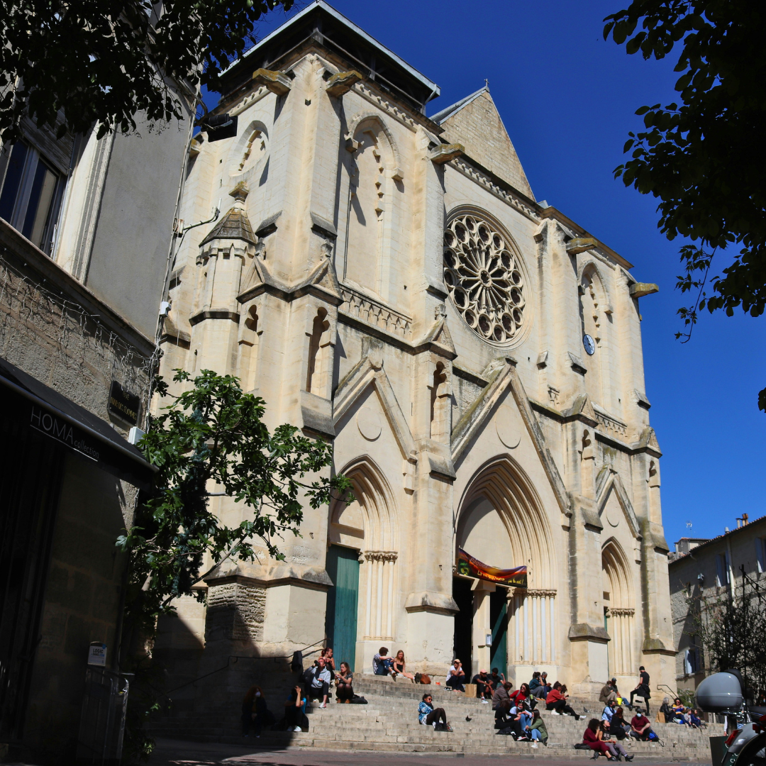 Photograph of a white, French church.